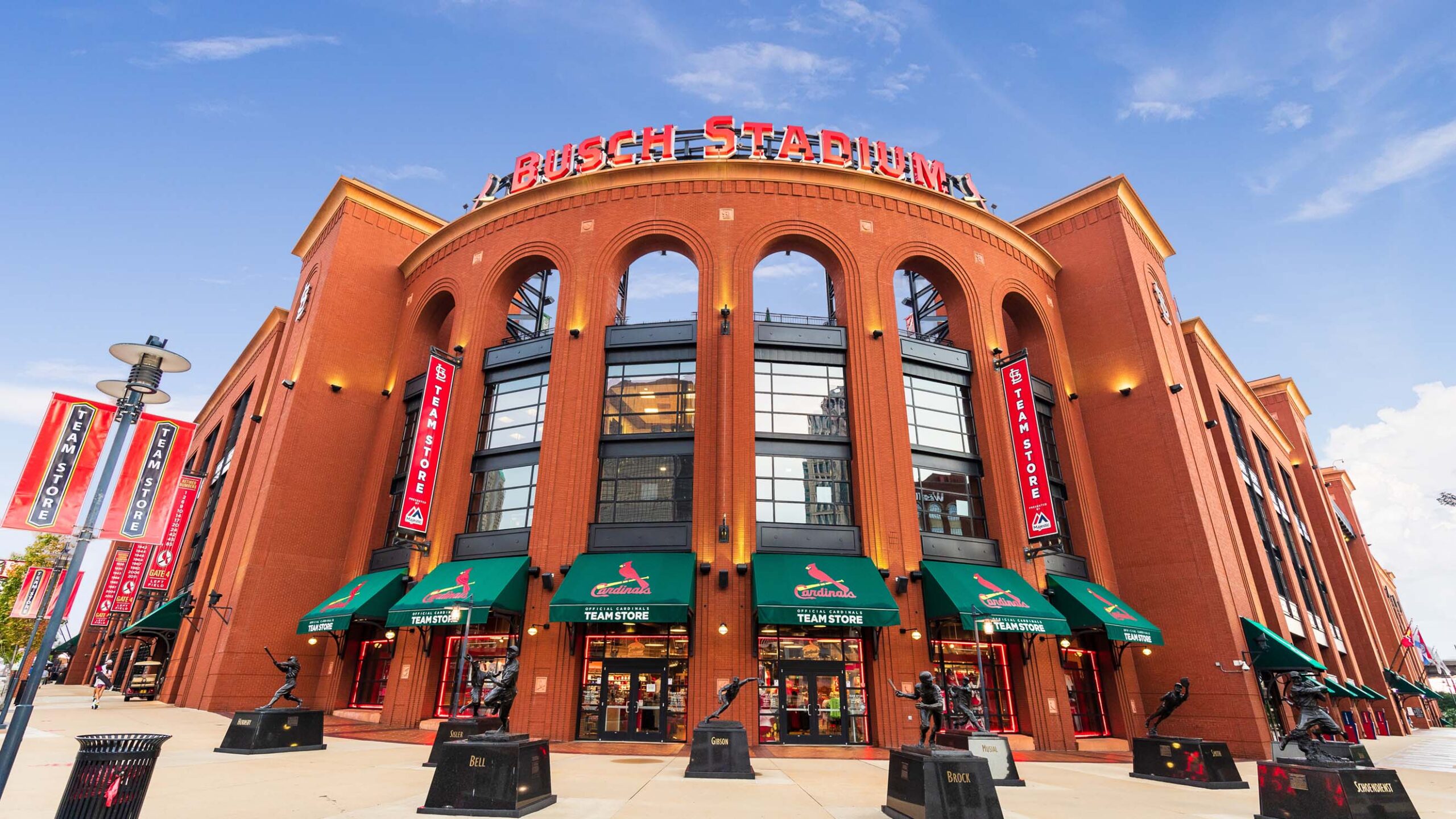 The facade of Busch Stadium with statues of historic Cardinals out front