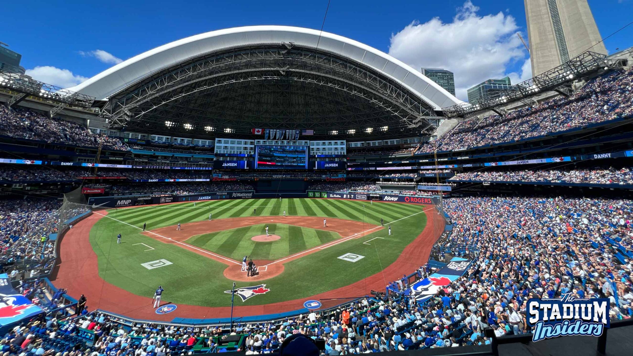 A packed Blue Jays game at Rogers Center on a beautiful day and CN Tower in the background