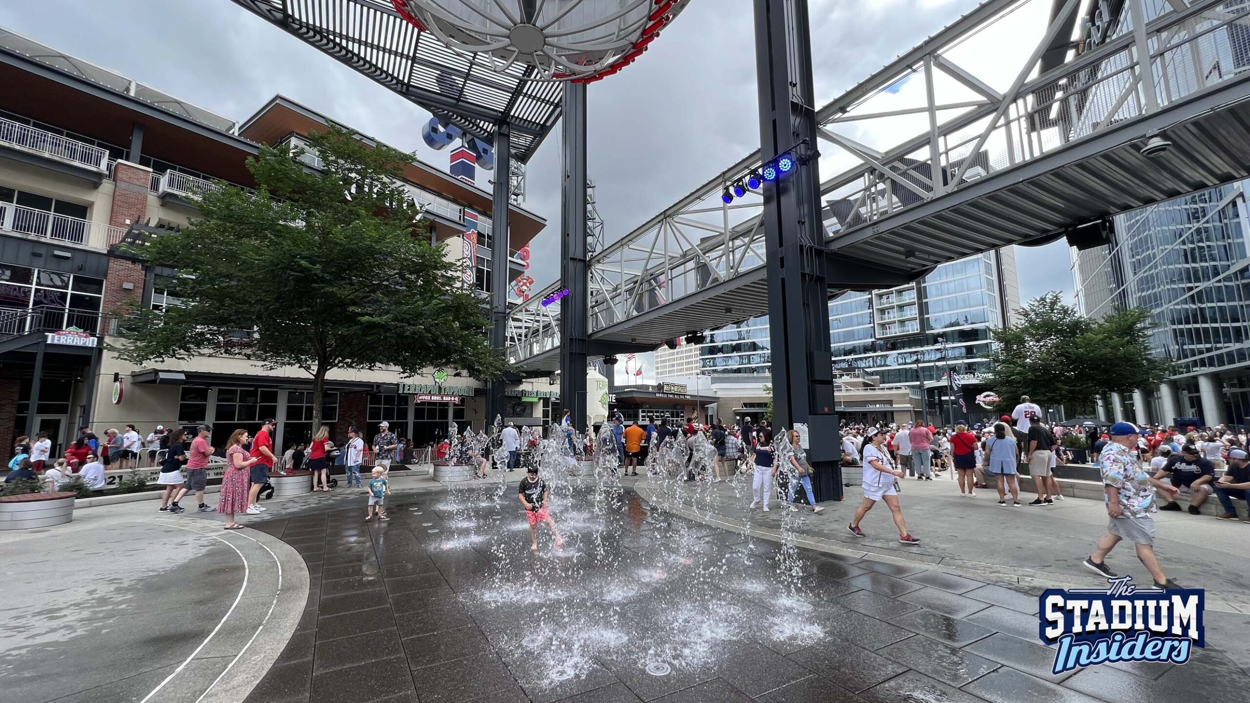 Water fountains pump streams of water up into the air on the concourse of The Battery outside Truist Park in Atlanta