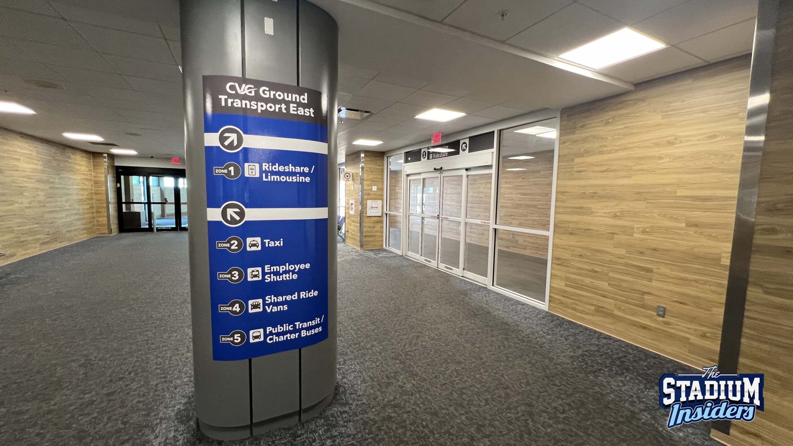 A sign inside CVG airport shows travelers which zones each transit option are in